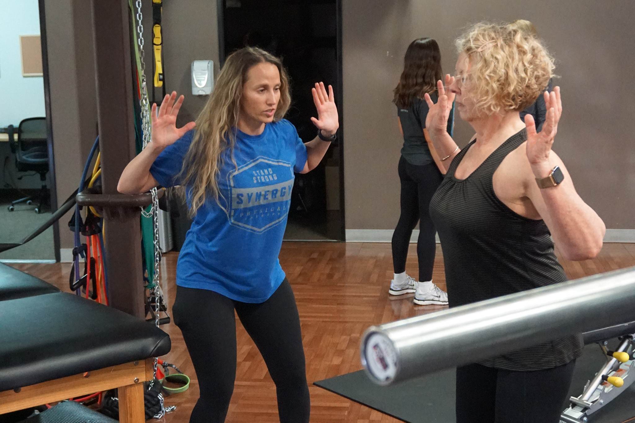 Physical therapist treating shoulder pain at Synergy Physical Therapy in Scottsdale, AZ